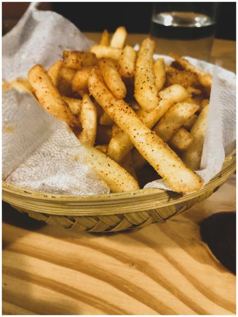 Close-up of seasoned french fries served in a rust