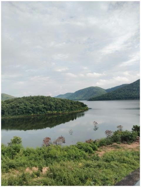 Peaceful view of a lake surrounded by green hills