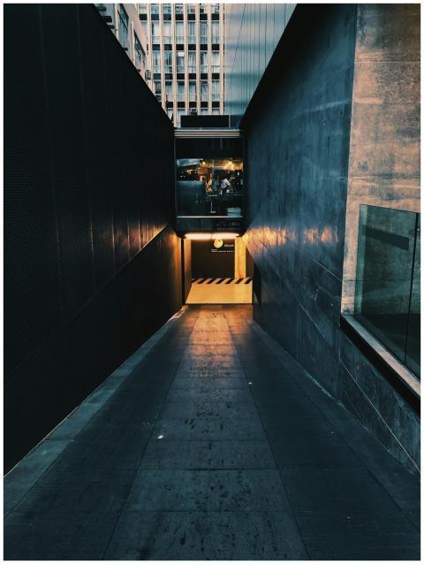 Dimly lit urban underground access with contrastin