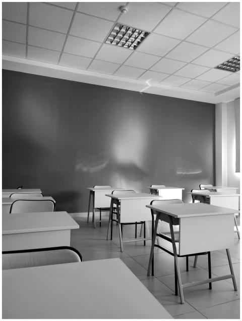 A minimalist black and white image of an empty cla