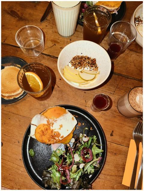 Top view of assorted brunch dishes on a rustic woo