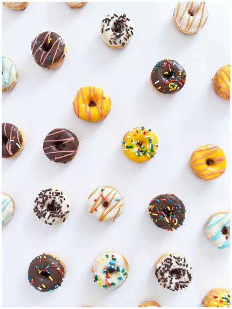 A variety of colorful doughnuts with sprinkles arr