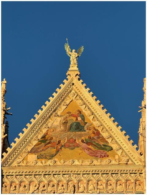 Detailed view of a cathedral facade with mosaic ar