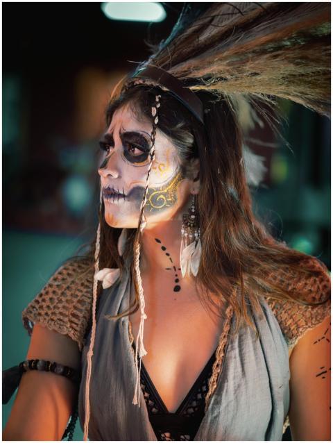 Woman with Day of the Dead makeup and costume, fea