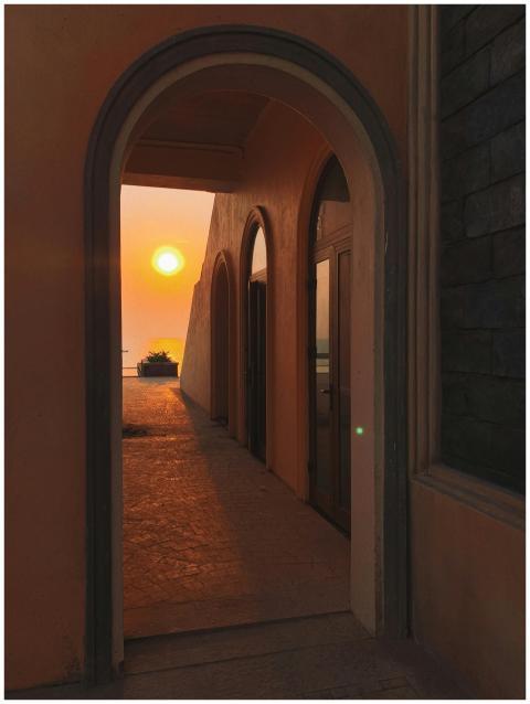 Beautiful sunset view through an arched hallway in