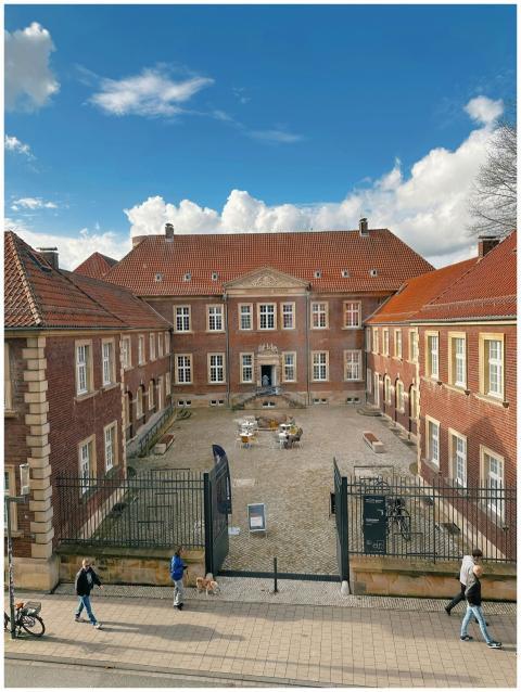 View of a historic brick building with a central c