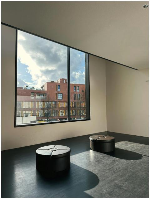 Spacious room with two stools and large window vie