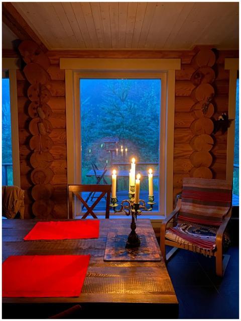 Warm candlelight on a wooden table in a rustic cab