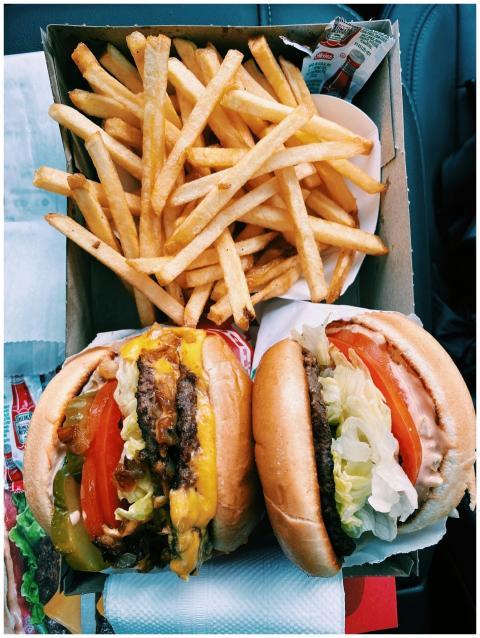 Top view of a tasty cheeseburger meal with fries,
