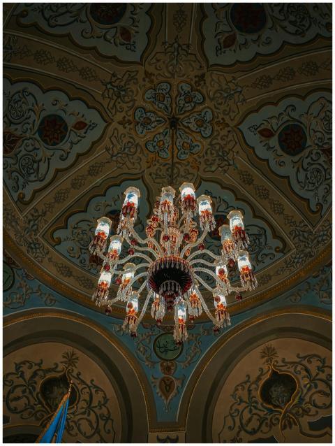 Luxurious chandelier in a lavishly ornate ceiling