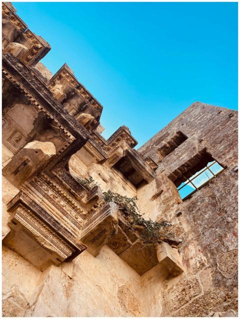 Detailed view of ancient architecture with blue sk