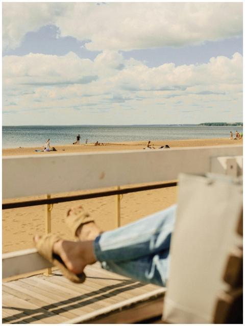 A serene beach scene with people relaxing, viewed