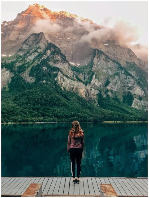Woman standing at Klöntalersee in Switzerland with