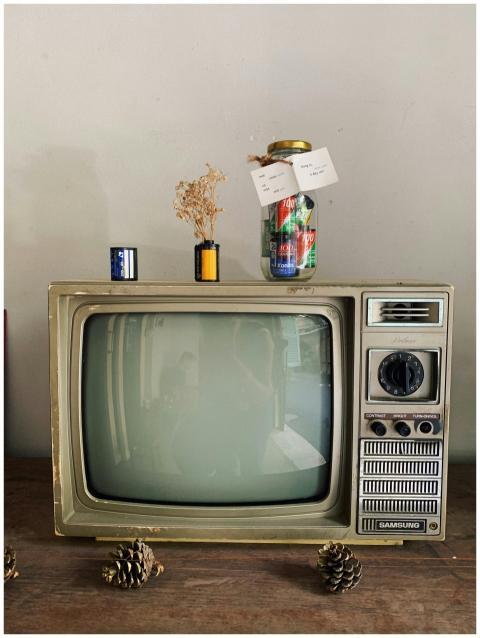 Vintage television set with jars and decor atop, c