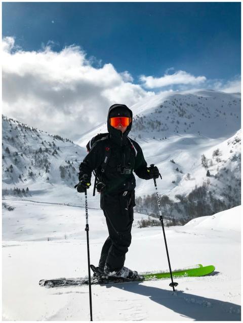 Energetic skier in black gear enjoying snowy slope