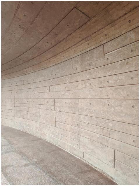 Curved wooden wall with geometric pattern in a Nan