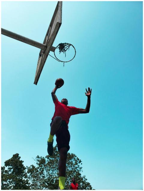 Dynamic shot of a basketball player jumping toward