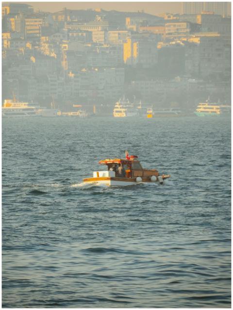 A small boat navigates the waters with Istanbul's