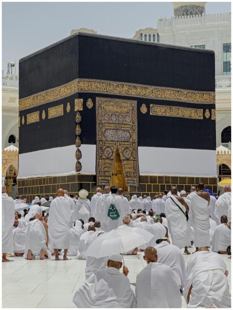 Pilgrims in white garments gather around the Kaaba
