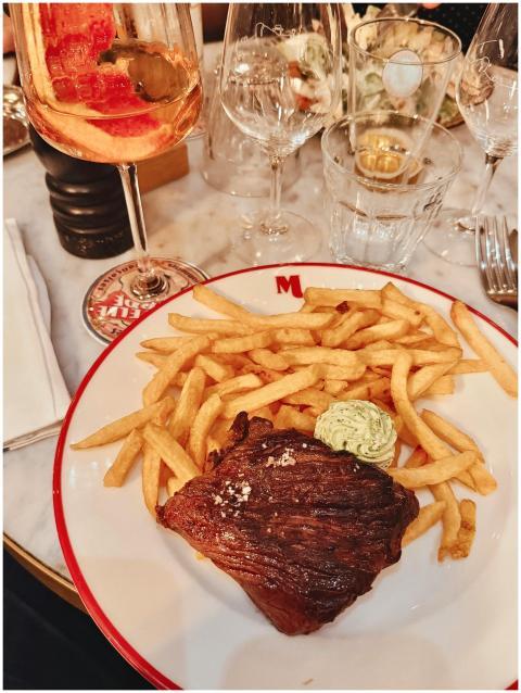 Delicious steak with fries and wine, perfect for a