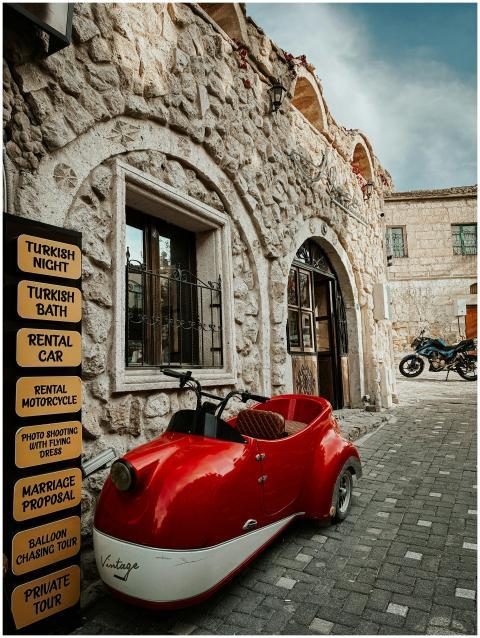 Charming vintage motorcycle parked outside a stone