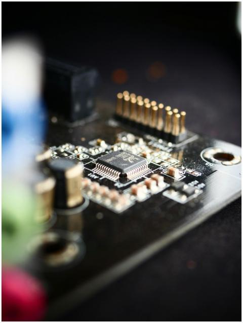 Detailed view of a microchip on a circuit board, s