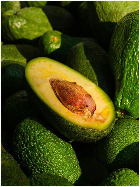 Close-up of a ripe avocado halved to reveal its se