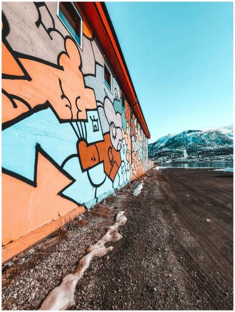 Vibrant graffiti art on a building wall with a sce