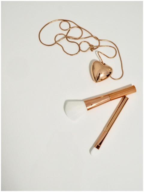 A charming flat lay of a heart-shaped pendant and
