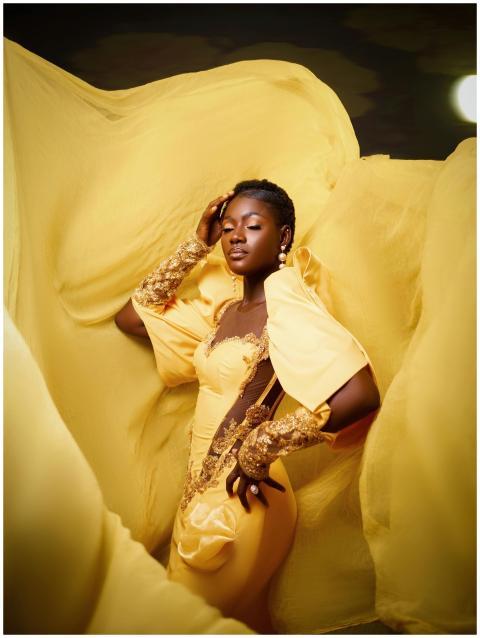 Elegant portrait of a black woman in a yellow dres