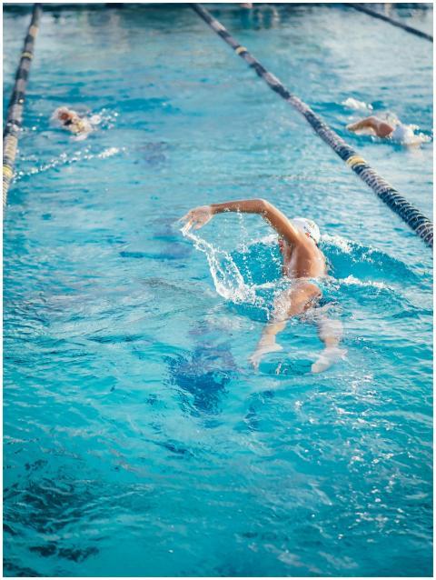 Adult swimmer practicing freestyle stroke in an ou