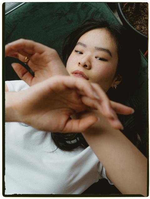 Artistic portrait of a woman lounging indoors with