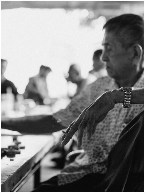 Black and white photo of an elderly man reflecting