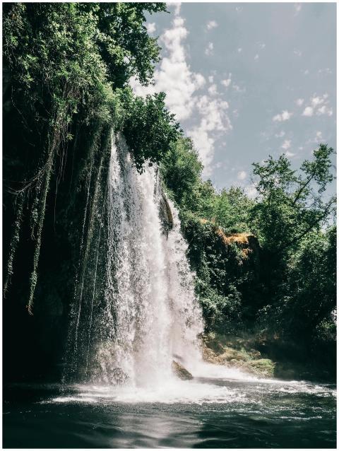 Breathtaking waterfall with lush greenery under a