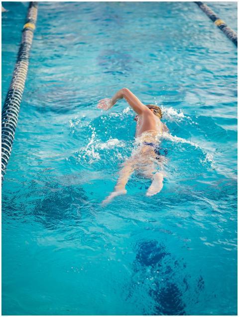Young male swimmer in action, performing a freesty