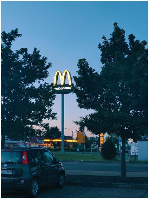 Fast food chain McDonald's signage glowing at twil