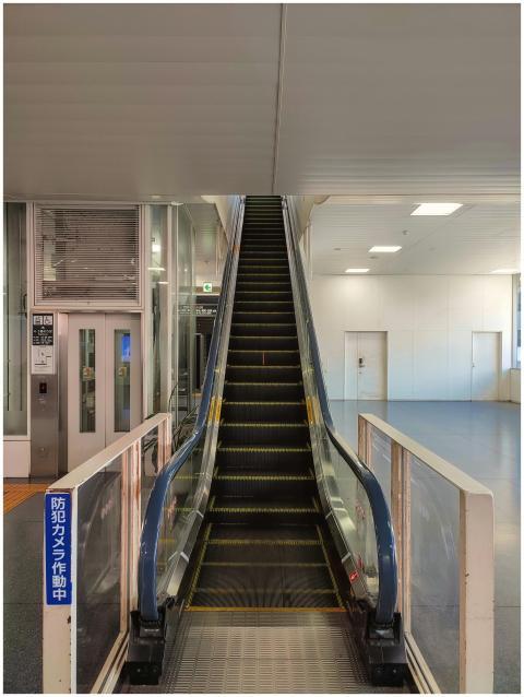 Escalator inside a modern Tokyo building with brig