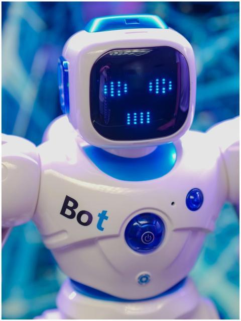 White humanoid robot toy with illuminated face dis