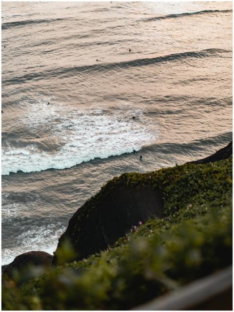 High angle view of a scenic ocean with surfers fro