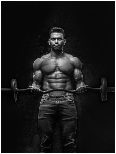 Black and white portrait of a muscular man lifting