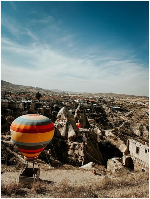 Vibrant hot air balloon hovering over Cappadocia's