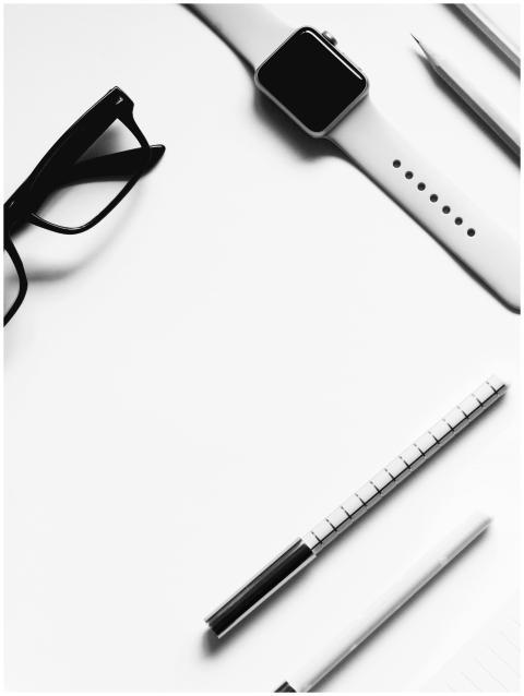 A sleek black-and-white flat lay of a modern offic