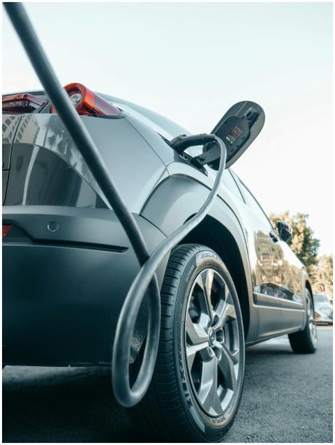 Close-up of an electric car charging at a modern c