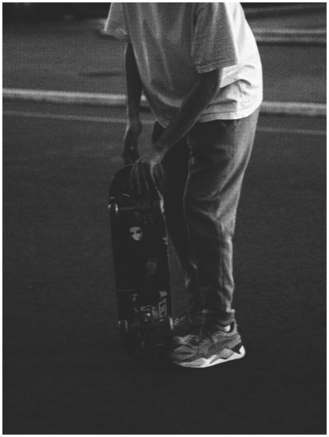 Black and white photo of a person with a skateboar
