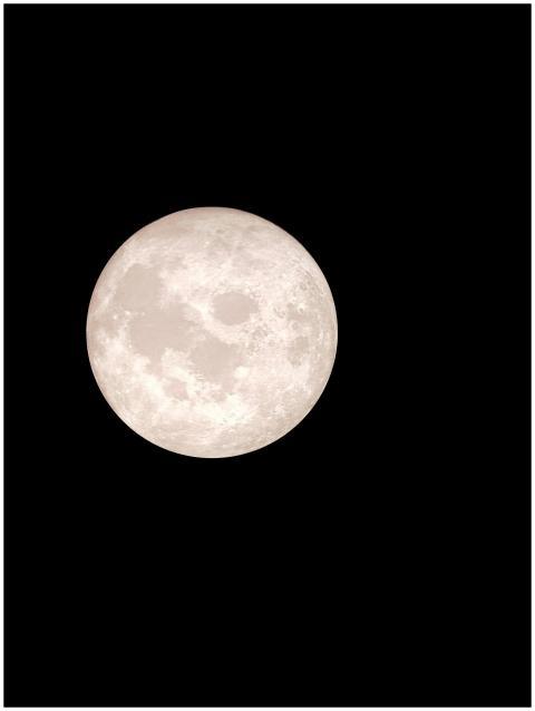 Bright full moon captured against a clear night sk