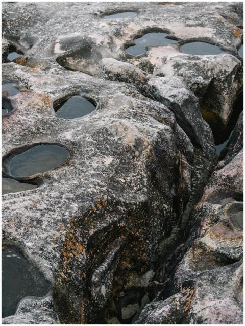 Rugged rocks with water puddles creating textured