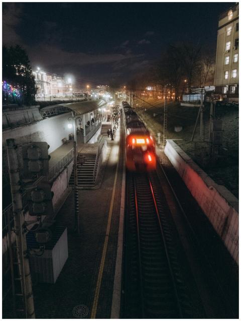 A night scene capturing a moving train at an illum