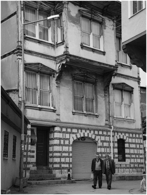 Black and white photo of historic building with tw