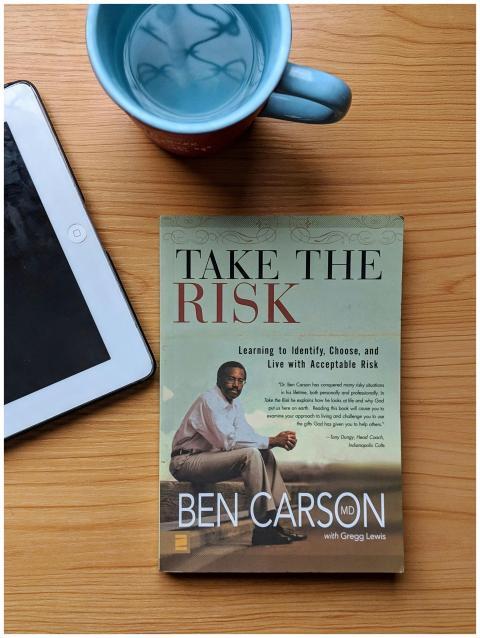 Top view of a Ben Carson book, tablet, and coffee