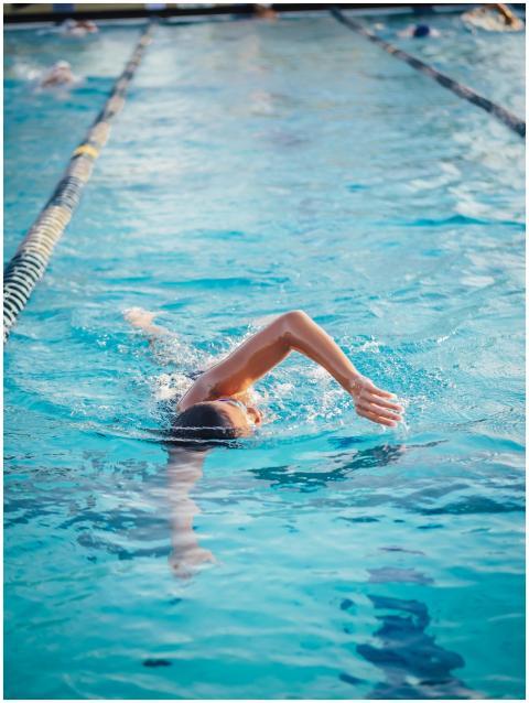 An athlete demonstrates freestyle swimming techniq